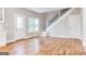 Bright living area with natural light, hardwood floors, and staircase access at 870 Gaston Sw St, Atlanta, GA 30310
