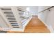 Hardwood staircase with modern black metal railing and bright natural light from windows, leading upstairs at 870 Gaston Sw St, Atlanta, GA 30310