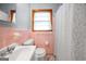 Cozy bathroom with pink tile, updated fixtures, and a window for natural light at 135 5Th Ave, Jonesboro, GA 30236
