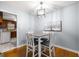 Cozy dining area with a modern light fixture and a view into the kitchen at 135 5Th Ave, Jonesboro, GA 30236