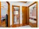 Bright hallway with wood floors, showcasing the entry to the bathroom and bedroom at 135 5Th Ave, Jonesboro, GA 30236
