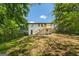 Backyard of home featuring a wooden deck with stairs descending to a large grassy area at 1400 North Avenue Nw, Atlanta, GA 30318