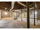 Unfinished basement featuring exposed pipes and support beams, plus concrete floor and block walls at 1400 North Avenue Nw, Atlanta, GA 30318