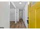 Inviting entryway featuring wood-look floors, a view of the hallway, and a striking yellow front door at 1400 North Avenue Nw, Atlanta, GA 30318