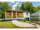 Charming home with a wood-accented porch, yellow door, painted brick, and a well-manicured front lawn at 1400 North Avenue Nw, Atlanta, GA 30318