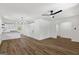 Open-concept living space with wood floors, white walls, a modern ceiling fan, and a view into the kitchen at 1400 North Avenue Nw, Atlanta, GA 30318