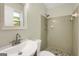 Cozy bathroom with a stone-tile shower and white vanity at 3180 S Elizabeth Dr, Douglasville, GA 30135