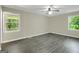 Bright bedroom with large windows offering a serene view, plus updated flooring and fixtures at 3180 S Elizabeth Dr, Douglasville, GA 30135