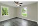 Comfortable bedroom with two large windows, ceiling fan and a pleasant view at 3180 S Elizabeth Dr, Douglasville, GA 30135