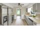 Well-lit kitchen featuring stainless appliances and gray cabinets at 3180 S Elizabeth Dr, Douglasville, GA 30135