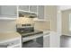 Stainless range with gray cabinets in a modern kitchen at 3180 S Elizabeth Dr, Douglasville, GA 30135
