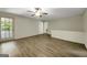 Spacious living room with new flooring, ceiling fan, and a door that opens to an outdoor view at 3180 S Elizabeth Dr, Douglasville, GA 30135