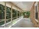 Relaxing screened porch with string lights, swing and views of the beautiful trees at 3180 S Elizabeth Dr, Douglasville, GA 30135