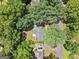 Aerial view of a home featuring mature trees, driveway, and lush landscaping in a peaceful setting at 3506 Billingsley Dr, Marietta, GA 30062