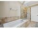 Bright bathroom featuring a soaking tub, tiled shower with glass door, and neutral color palette at 3506 Billingsley Dr, Marietta, GA 30062