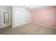 Bedroom showcasing pink accent wall, neutral carpet, and closet at 3506 Billingsley Dr, Marietta, GA 30062