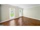 Bedroom featuring hardwood floors, neutral walls, and window views of the front yard at 3506 Billingsley Dr, Marietta, GA 30062