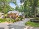 Stately brick home featuring a long driveway, mature trees, and manicured landscaping at 3506 Billingsley Dr, Marietta, GA 30062