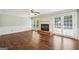 Cozy living room featuring hardwood floors, fireplace, and sliding glass doors to backyard at 3506 Billingsley Dr, Marietta, GA 30062