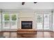 Well-lit living room with a fireplace and windows overlooking the backyard at 3506 Billingsley Dr, Marietta, GA 30062