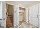 Mudroom featuring bi-fold closet, exterior door, and staircase access at 3506 Billingsley Dr, Marietta, GA 30062