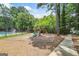 Community playground area with swings and slide, nestled among mature trees and adjacent to a pool at 3506 Billingsley Dr, Marietta, GA 30062