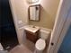 Practical half-bathroom with a vanity and toilet, offering convenience for guests at 718 Hardy Way, Hiram, GA 30141