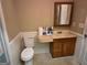 Compact bathroom with a vanity and toilet, providing essential amenities at 718 Hardy Way, Hiram, GA 30141
