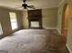 Spacious living room boasts natural light and a classic brick fireplace, perfect for gatherings at 718 Hardy Way, Hiram, GA 30141