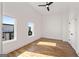 Minimalist bedroom with hardwood floors, abundant natural light, and a ceiling fan at 1836 Memorial Dr # 303, Atlanta, GA 30317