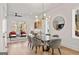 Dining room with modern chandelier, glass table, and view into living room at 1836 Memorial Dr # 303, Atlanta, GA 30317