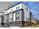 Modern townhome with a two-car garage and mixed material exterior, including light gray siding and brick at 1836 Memorial Dr # 303, Atlanta, GA 30317
