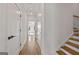Hallway with hardwood floors and white trim leads to the stairs and bedroom at 1836 Memorial Dr # 303, Atlanta, GA 30317
