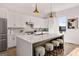 Modern kitchen with white cabinets, marble countertops, and a large island with seating at 1836 Memorial Dr # 303, Atlanta, GA 30317