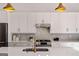Close up of modern kitchen details including white backsplash, stainless appliances and stone countertop at 1836 Memorial Dr # 303, Atlanta, GA 30317