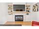Living room with a fireplace, custom built-ins, and open shelving at 1836 Memorial Dr # 303, Atlanta, GA 30317
