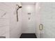 Shower stall features subway tile walls, black tile floor, and gold fixtures at 1836 Memorial Dr # 303, Atlanta, GA 30317