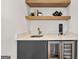 Contemporary wet bar with open shelving, quartz counters, and wine refrigerator at 1836 Memorial Dr # 303, Atlanta, GA 30317