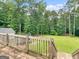 Expansive backyard view from wooden deck with lush green lawn and mature trees at 79 The Farm Rd, Mcdonough, GA 30252