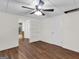 Spacious room featuring new flooring and ceiling fan with a door leading to updated bathroom at 79 The Farm Rd, Mcdonough, GA 30252