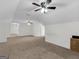 Expansive bonus room featuring neutral carpeting and a ceiling fan for comfort and entertainment at 79 The Farm Rd, Mcdonough, GA 30252