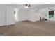 Bonus room showcasing a large space with neutral carpeting and ceiling fans for comfortable living at 79 The Farm Rd, Mcdonough, GA 30252