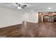 Spacious living room with wood grain flooring, ceiling fan, and doorway to a full kitchen at 79 The Farm Rd, Mcdonough, GA 30252