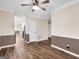 Spacious living room with hardwood floors, ceiling fan, and entry to the kitchen at 79 The Farm Rd, Mcdonough, GA 30252