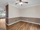 Open-concept living area with laminate flooring, decorative crown molding, and custom two-tone paint at 79 The Farm Rd, Mcdonough, GA 30252