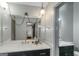 Clean bathroom with modern lighting, double vanity with black cabinets and unique mirror at 959 Sweet Briar Se Trl, Conyers, GA 30094