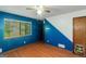 Bright bedroom featuring blue accent wall, ceiling fan, and wood-look flooring for a modern look at 959 Sweet Briar Se Trl, Conyers, GA 30094