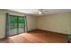 Comfortable bedroom with a private balcony, ceiling fan, hardwood floors, and neutral paint scheme at 959 Sweet Briar Se Trl, Conyers, GA 30094