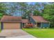 Charming home with a two-car garage, complemented by a well-manicured lawn and vibrant shrubbery at 959 Sweet Briar Se Trl, Conyers, GA 30094