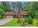 Charming home with a two-car garage, complemented by a well-manicured lawn and mature trees at 959 Sweet Briar Se Trl, Conyers, GA 30094
